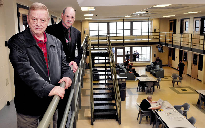 Somerset County Sheriff Barry DeLong, left, and Maj. David Allen stand on a balcony overlooking an inmate pod filled with prisoners at the Somerset County Jail in East Madison on Wednesday. The jail started accepting out-of-county inmates again after a dispute with state officials over the cost of incarcerating them.