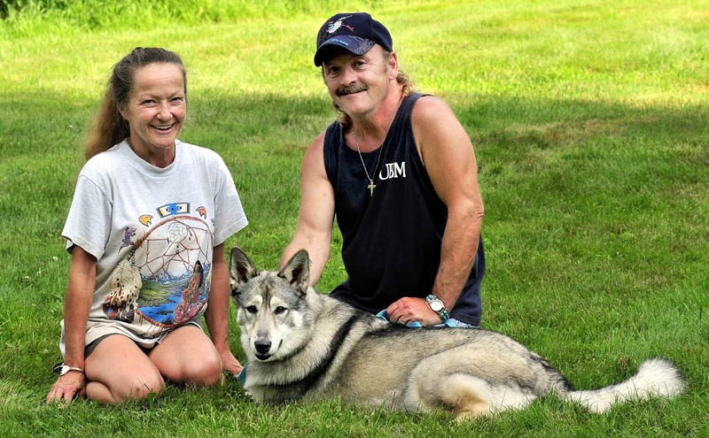FAMILY: Julie and Gene Mitchell of Detroit with their two-year-old wolf hybrid named Wolf.