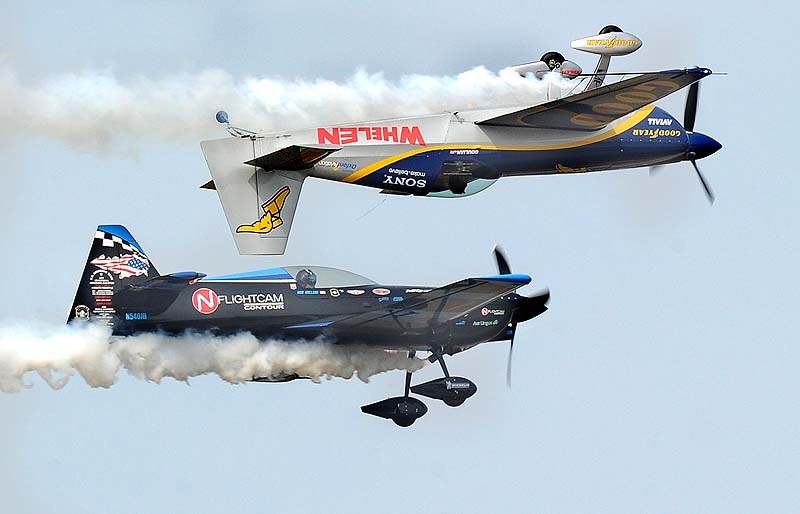 Pilot Rob Holland, bottom left, and Mike Goulian perform during The Great State of Maine Air Show at Brunswick Executive Airport on Saturday.