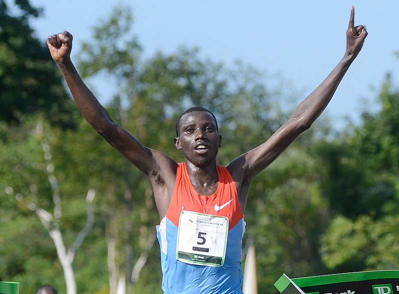 Stanley Biwott of Kenya crosses the finish line first in the 2012 TD Beach to Beacon 10k in Cape Elizabeth Saturday.