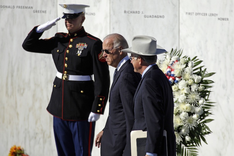 Vice President Joe Biden, center, and Interior Secretary Ken Salazar, right, walk in front of The Wall of Names, containing the names of the 40 passengers and crew of Flight 93, as they arrive for a memorial service at the Flight 93 National Memorial in Shanksville, Pa., Tuesday, Sept. 11, 2012. (AP Photo/Gene J. Puskar)