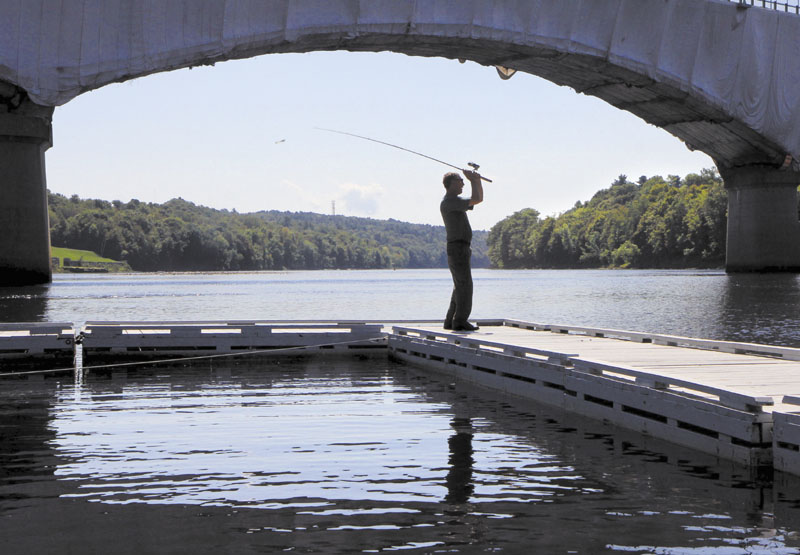 A NICE CAST: Pat Merrill of Lewiston fishes for smallmouth bass on the Kennebec River in Augusta at the East Side Boat Landing Park on Friday. Moments earlier Merrill said he caught a nice 14-inch small bass. "The fish are starting to bite again. The water is starting to cool down a bit," said Merrill.