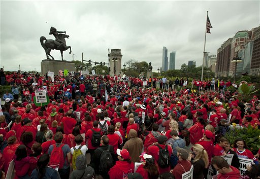 A crowd of public school teachers rally at Chicago's Congress Plaza on Thursday to protest against billionaire Hyatt Hotel mogul Penny Pritzker, who is also a member of the Chicago Board of Education. Protesters said that $5.2 million in Tax Increment Financing (TIF) funds being used to build a new Hyatt hotel in Hyde Park would be better spent on meeting basic student needs.