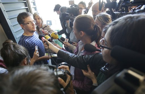 Publishing director of the satyric weekly Charlie Hebdo, Charb, holds the newspaper as he talks to the media in Paris on Wednesday. Police took up positions outside the weekly's offices after it published crude caricatures of the Prophet Muhammad that ridicule the U.S.-produced film "Innocence of Muslims" and the furor surrounding it. The weekly was firebombed last year after it released a special edition that portrayed the Prophet Muhammad as a "guest editor" and took aim at radical Islam.