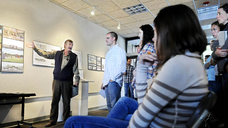 GRAND DESIGN: City of Augusta Director of Community Services Leif Dahlin discusses a design for a lodge at the Bond Brook Recreation Area with University of Maine at Augusta architecture students Monday in Augusta. Dahlin and other Judges selected two prospective designs from several submitted by the students after touring Bond Brook in early September.