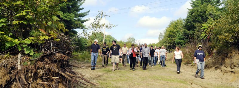 Dr. William Rogers, left, leads University of Maine at Augusta architecture students down a trail Thursday at the Bond Brook Recreation Area in Augusta. The students toured the trails for skiers, hikers and bikers to design a lodge proposal.