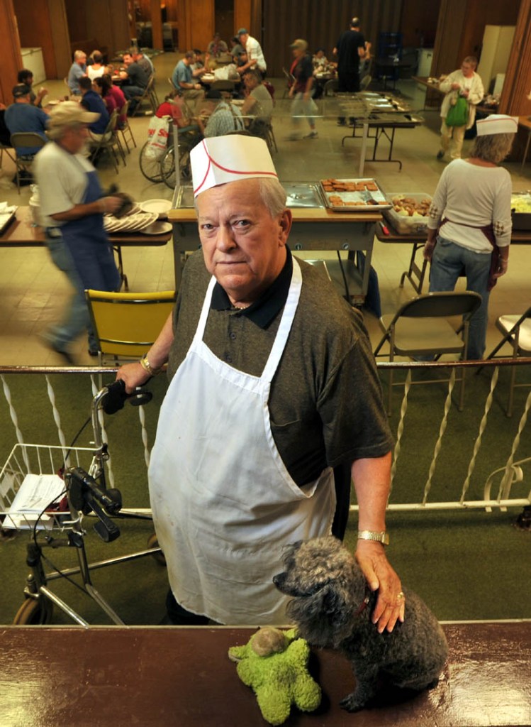 Dick Willette and his dog Angel pose for a portrait at the Sacred Heart Soup Kitchen in the basement of Sacred Heart Church on Pleasant Street in Waterville during the lunch-time serving Friday. Willette was able to celebrate hi 32nd year of serving the poor with over $68,000 in donations to ensure the service will be provided through 2014.
