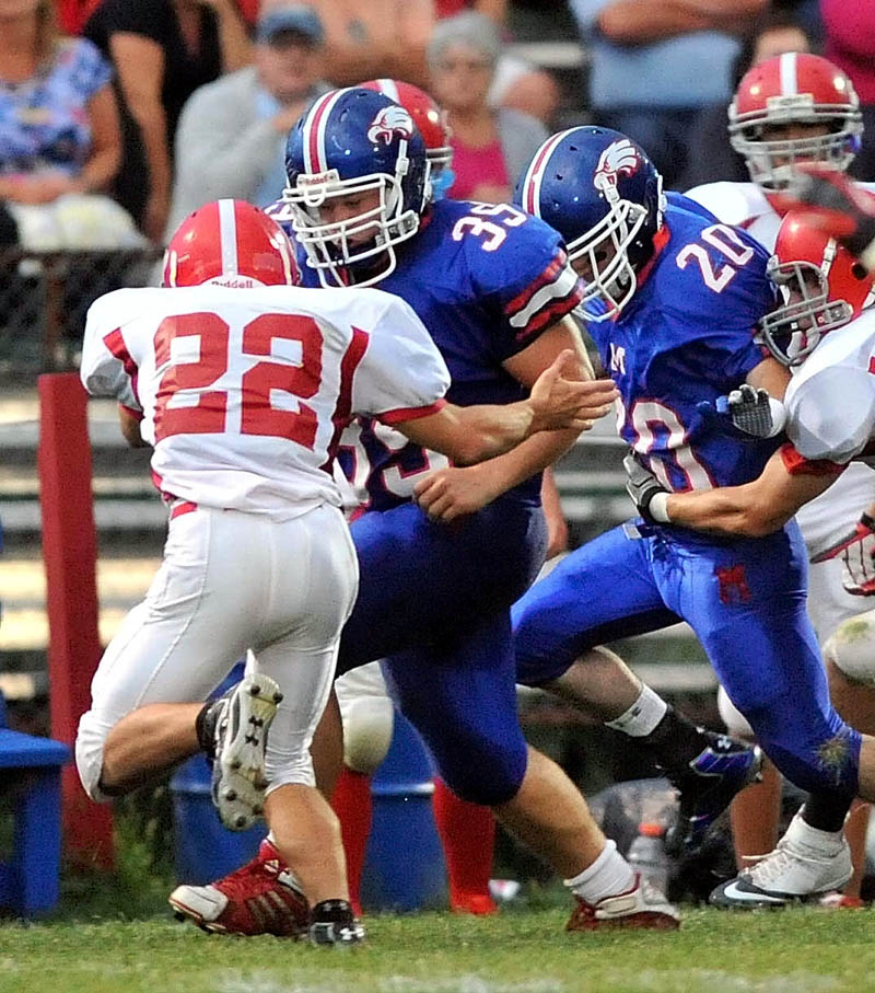 Messalonskee High School fullback Jake Stinson (39) blocks for teammate Corey McKenzie (20) against Cony High School earlier this season.