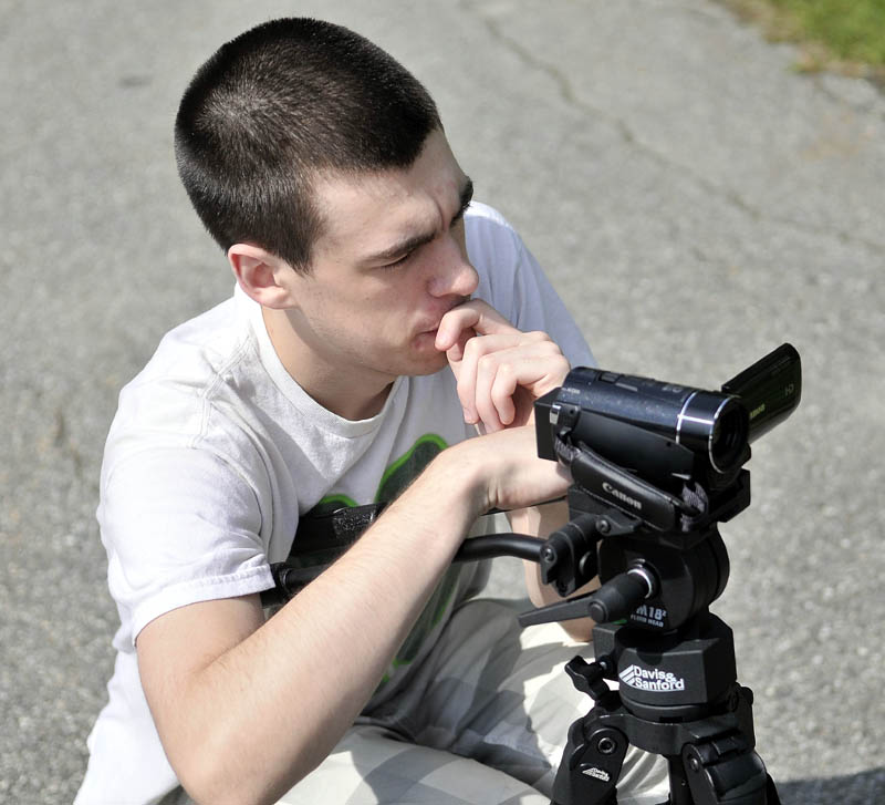 Staff photo by Michael G. Seamans Patrick Ayers, 17, films fellow classmate Connor Chapman, during Mass Media Communication's class at Mid-Maine Technical Center at waterville Senior High School Thursday. Students were working on a 35 second project video of another student during class time.