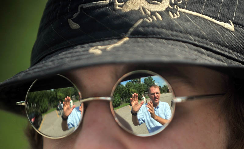 Staff photo by Michael G. Seamans Dave Boardman, reflected in glasses, teacher of Mass Media Communication's class at Mid-Maine Technical Center at Waterville Senior High School offers instruction to student Erik Mathews, 17, during class Thursday. Students were working on a 35 second project video of another student during class time.