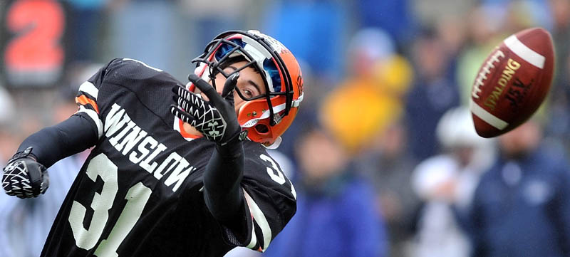 Staff photo by Michael G. Seamans Winslow High School's Ricky Crayton, 31, tries to make a catch in the second quarter against Yarmouth Academy in Winslow Saturday.