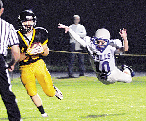 SCORE: Maranacook tight end Andrew Lachance, left catches a 21-yard touchdown pass as Old Orchard Beach defensive back Tyler Scott dives in vain to stop him Friday at Ricky Gibson Field of Dreams in Readfield.