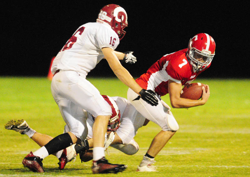 TANDEM TAKEDOWN: Bangor defenders Nick Ashley, top, and Matt Cosgrove tackle Cony’s Chandler Shostak during a game Friday night at Alumni Field in Augusta.