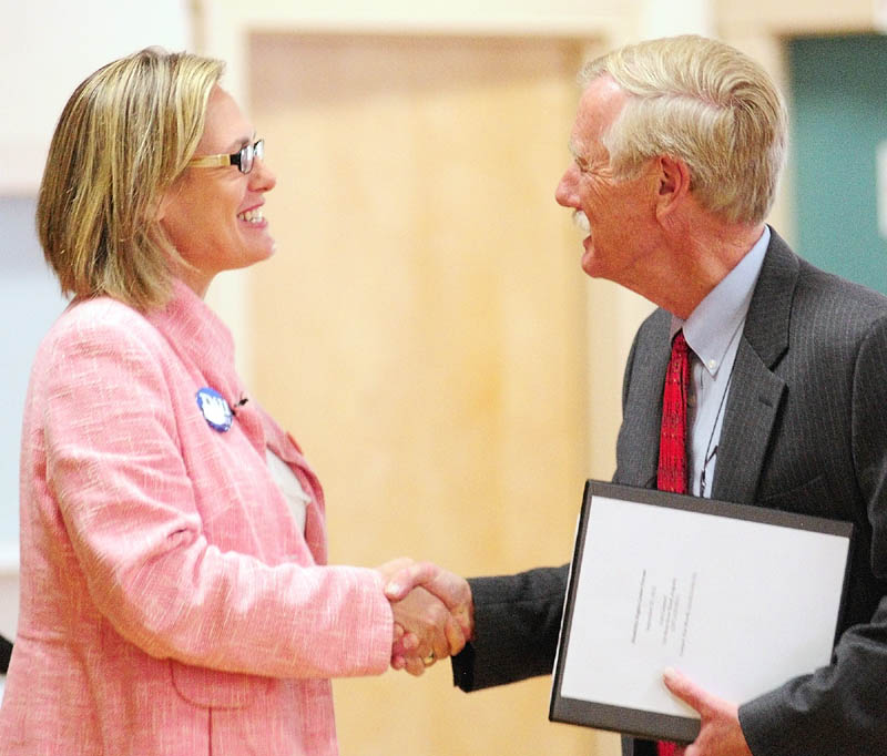 Democratic U.S. Senate candidate Cynthia Dill, left, greets Independent U.S. Senate candidate Angus King before she speaks during the U.S. Senate Candidates Forum hosted by Disability Rights Center and a coalition of organizations at Le Club Calumet on Thursday in Augusta.