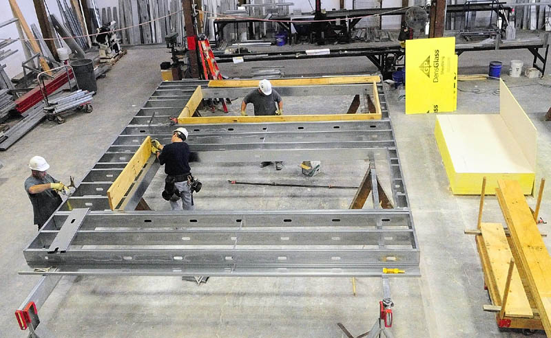 Workers build exterior wall panels for the new MaineGeneral regional hospital last week at the Porter Panel & Truss in Portland. The sections are build there, transported to Augusta and lifted into place by crane.