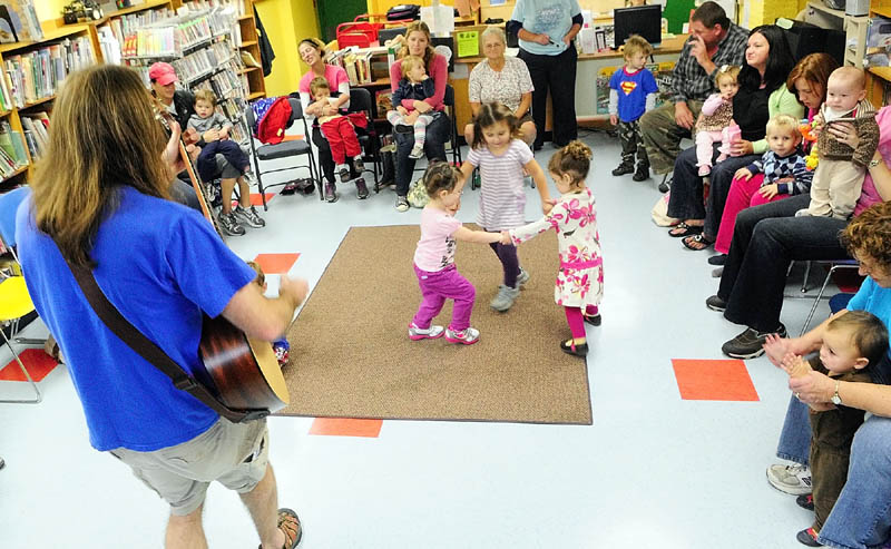 Staff photo by Joe Phelan Harley Smith, whose stage name is Mr. Harley, performs Wednesday morning in the children's room of the The Charles M. Bailey Public Library in Winthrop.