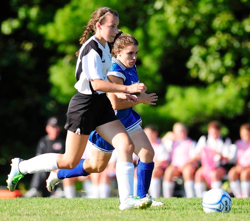 GOAL-SCORING MOVE: Hall-Dale’s Maura Stottler, left, breaks toward the goal as Oak Hill’s Sarah Carpenter pursues during a game on Wednesday afternoon at Hall-Dale High School in Farmingdale. Stottler scored on the play to give the Bulldogs a 1-0 lead in the first half.