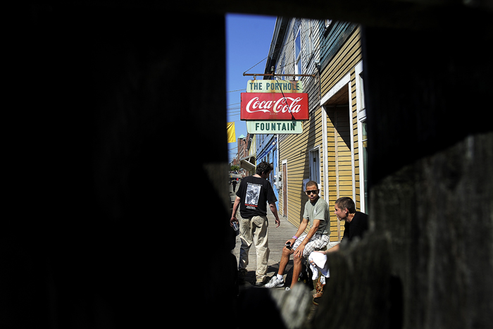 Employees of The Porthole on Custom House Wharf wait outside the building Friday afternoon after the restaurant, along with the Comedy Connection and Harbour’s Edge, were shut down because of numerous health code violations. Business owner Oliver Keithly did not respond to calls for comment Friday, and employees at the Porthole said he was not inside.