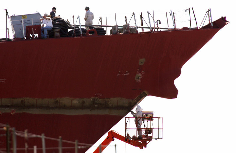 Bath Iron Works employees construct a Navy destroyer in 2005. General Dynamics, parent company of BIW, awaits reports on how the Obama administration plans to carry out mandated spending cuts on defense programs if Congress fails to act.
