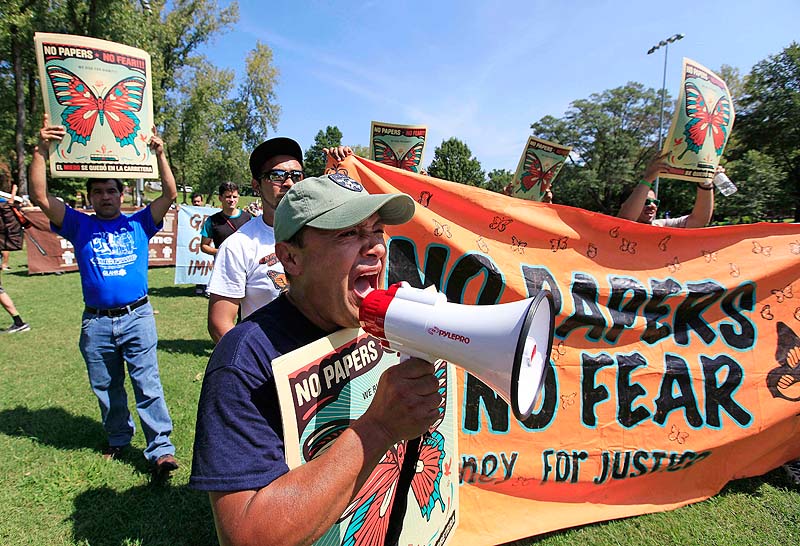 Demonstrators speak during a protest march in Frazier Park Sunday in Charlotte, N.C. Demonstrators are protesting before the start of the Democratic National Convention.