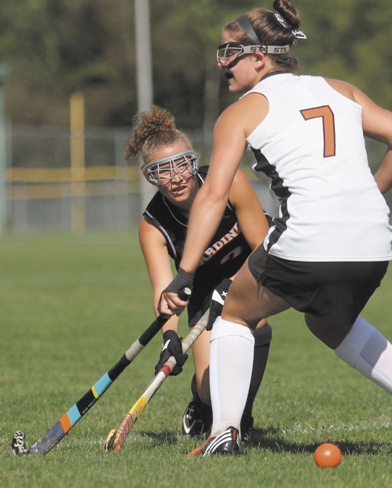 PASSING THROUGH: Gardiner Area High School's LeeAnne Greenleaf puts a pass by Winslow High School's Allie LeClair in the first half of Monday's game in Winslow.