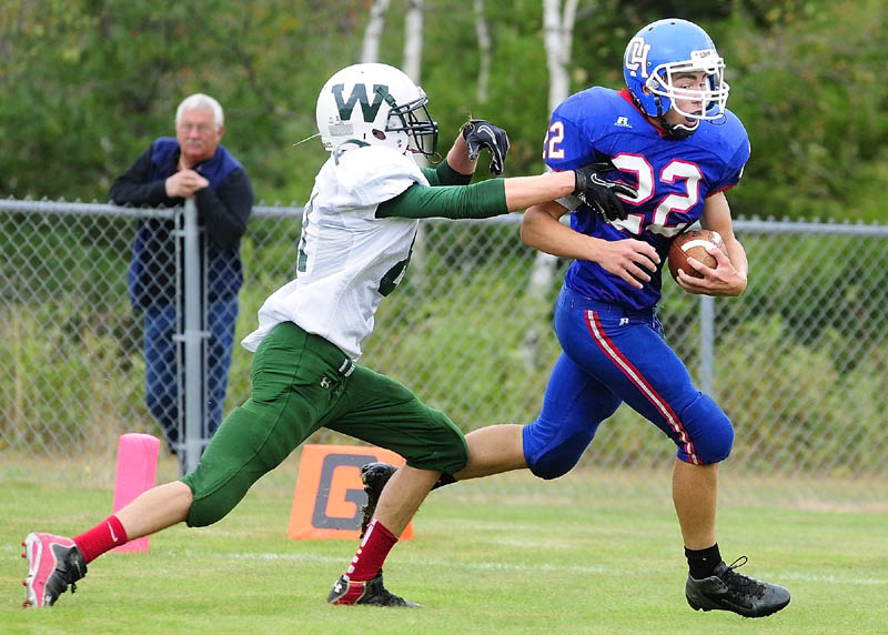 HE’S GONE: Winthrop cornerback Dakota Carter, left, chases Oak Hill running back Alex Mace into the end zone as Mace scores a touchdown on Saturday afternoon at Oak Hill High School in Wales. Mace scored three first quarter touchdowns and Oak Hill won 49-0.