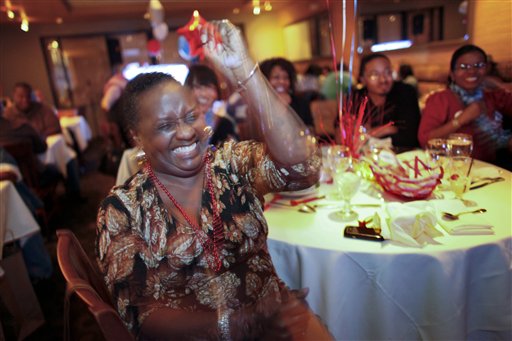 Harriet Garrett reacts while watching the first Presidential debate between Republican presidential candidate, former Massachusetts Gov. Mitt Romney, and President Barack Obama on Wednesday Oct. 3, 2012, at a restaurant in the West Oak Lane section of Philadelphia. (AP Photo/ Joseph Kaczmarek)