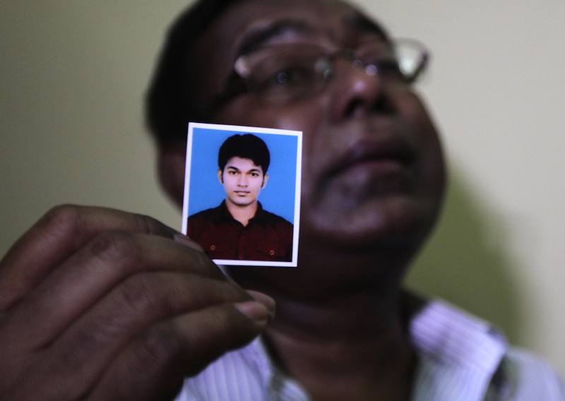 Bangladeshi Quazi Ahsanullah displays a photograph of his son Quazi Mohammad Rezwanul Ahsan Nafis as he weeps in his home in the Jatrabari neighborhood in north Dhaka, Bangladesh, Thursday, Oct. 18, 2012. The FBI arrested 21-year-old Nafis on Wednesday after he tried to detonate a fake 1,000-pound (454-kilogram) car bomb, according to a criminal complaint. His family said Thursday that Nafis was incapable of such actions. (AP Photo/A.M. Ahad)