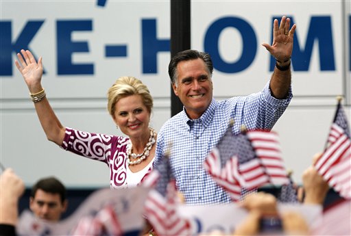 Republican presidential candidate Mitt Romney waves as he arrives with his wife Ann at a campaign rally, Sunday, in Port St. Lucie, Fla.