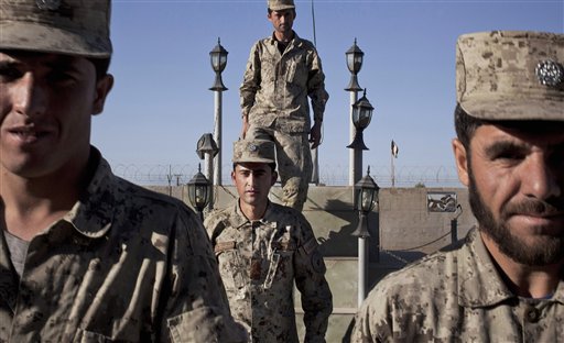 Afghan National Police line up after the official ceremony to take down the flag at the end of the day at their base in Lashkar Gah, Helmand, Afghanistan, on Wednesday.