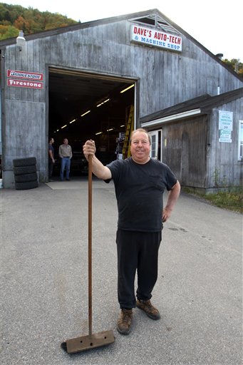 David Viger poses in front of his shop, Dave's Auto Tech in Berlin, N.H., last week. While polls show Obama's lead widening, Berlin resident David Viger says he's still eager to vote for Mitt Romney.