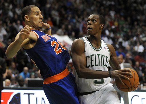 Rajon Rondo, right, and the Boston Celtics take on the defending champion Miami Heat in their season opener Tuesday night.