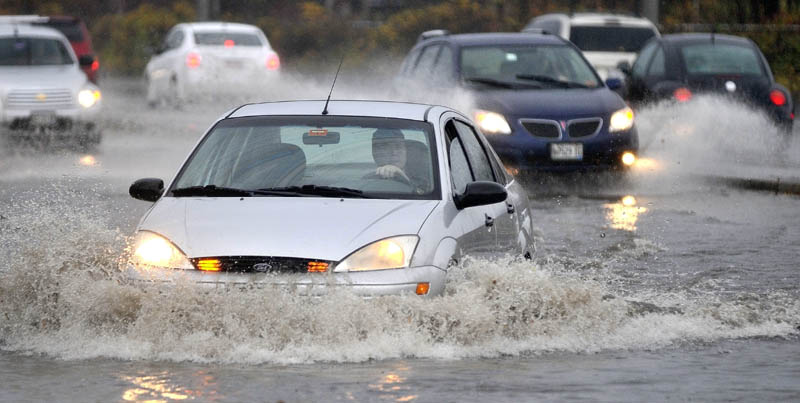 Commuters encounter floodwater on the Waterville side of the Ticonic Bridge, after heavy rain fell in Waterville on Tuesday.