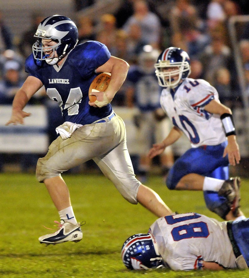 Lawrence High School runningback Jacob Gerow, 24, breaks away from Messalonskee High School defender Ryans Fecteau, 80, right, in the second quarter at Lawrence High School in Fairfield Friday.