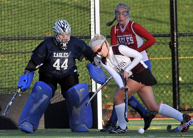 TAKE THE SHOT: Nokomis’ Lindsay Whitney, center, tries to take a shot on Messalonskee goalie Abby Roberts (44) as Mikayla Turner tries to defend in the first half of a Kennebec Valley Athletic Conference playoff game Thursday at Thomas College in Waterville.