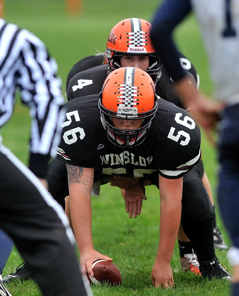 LEADING THE WAY: Winslow High School’s Sean Cote, center, prepares to snap the ball to quarterback Bobby Chenard dring a game earlier this year. Cote is one of four seniors — along with Jon Farrell, Brock Deschaine and Owen Dutil — on Winslow’s offensive line this season.