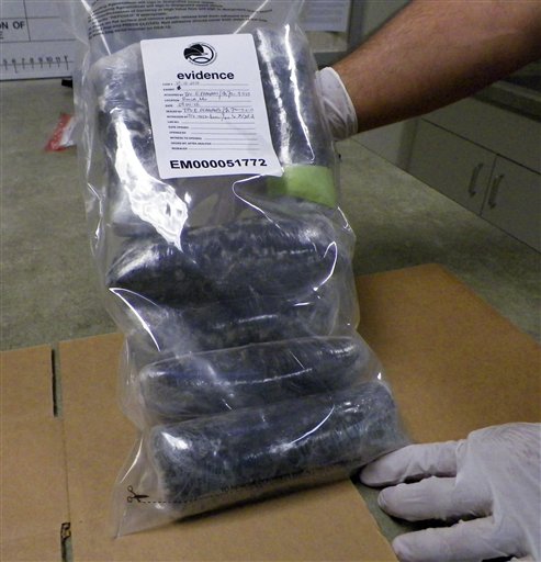 In this Sept. 7, 2012, photo, a U.S. Drug Enforcement Administration technician holds several pounds of Mexican meth confiscated in the St. Louis area. The DEA says the Mexican cartels are making the meth more pure, creating a faster and easier high for users, and they're selling it more cheaply in hopes of creating a new market. Seizures at the border and in several U.S. cities are up sharply.