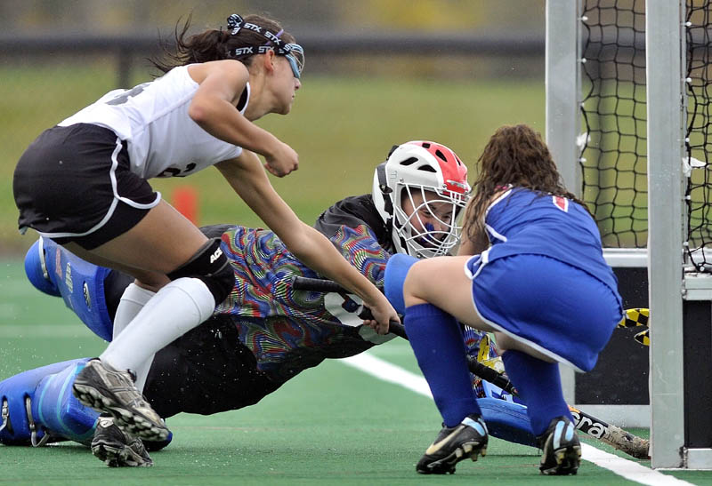 SCORE THE GOAL: Skowhegan’s Rylie Blanchet, left, scores a goal on Mt. Ararat goalie Taylor Pare, center, while Paige Perry, right, tries to defend during the Indians 11-0 win in the Eastern A regional semifinals Saturday at Colby College in Waterville.