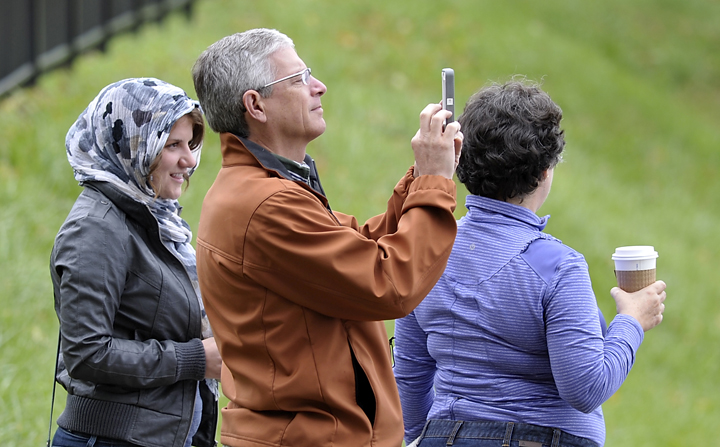 Lisa Mrzlack and her parents, Bob and Susan Mrzlack of Monticello, Ind., check out The World in Rockland Harbor on Friday. The yacht, which set sail in 2002, makes its way around the world.