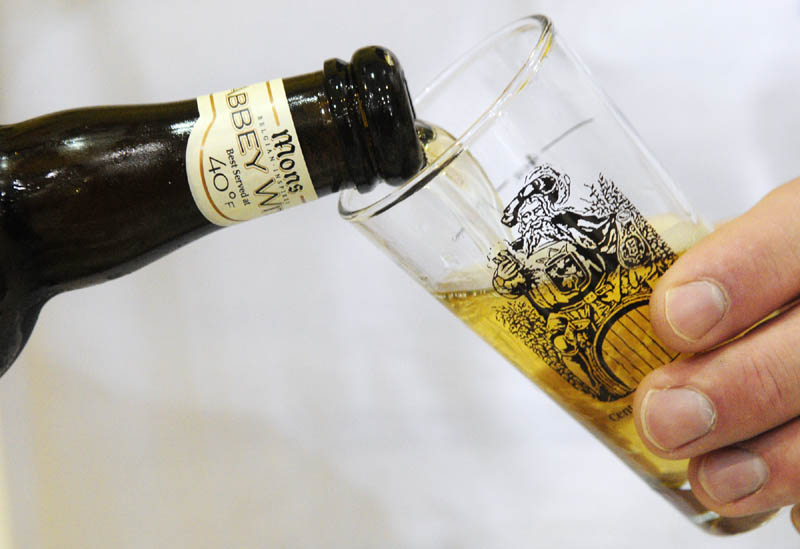 Jim Ross pours a small tasting glass of Mons Blonde on Saturday during at the Central Maine International Octoberfest at the Augusta Armory.
