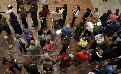 FILE - This Oct. 29, 2012 file photo shows people standing in line to vote during early voting for the presidential election, in Miami. One week before a close election, superstorm Sandy has confounded the presidential race, halting early voting in many areas, forcing both candidates to suspend campaigning and leading many to ponder whether the election might be postponed. It could take days to restore electricity to all of the more than 8 million homes and businesses that lost power when the storm pummeled the East Coast. That means it�s possible that power could still be out in some states on Election Day _ a major problem for areas that rely on electronic voting machines. (AP Photo/Lynne Sladky, File)