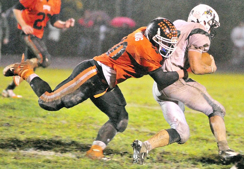 MAKING THE PLAY: Gardiner lineback Seth Wing tackles Leavitt back Brian Bedard during a game Friday at Hoch Field in Gardiner.