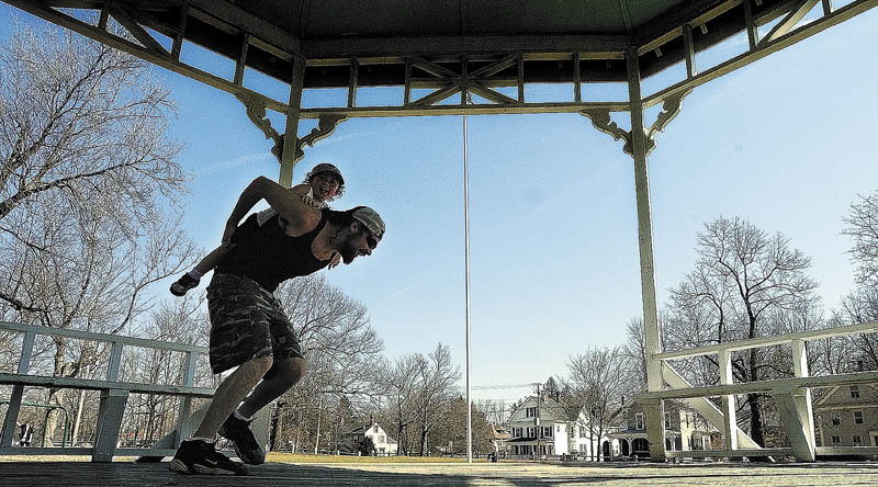 Staff photo by Joe Phelan This March 2012 file photo shows Michael McLaughlin giving his son a piggy-back ride around the gazebo on the common in Gardiner.