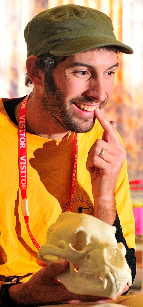 Leigh Rose points at his own canine tooth and tells students that human have smaller ones than the bear skull in his other hand on Wednesday afternoon at Gilbert School in Augusta. Leigh Rose, from the L. C. Bates Museum outreach program, has been visiting the school as part of six week program.