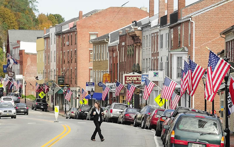 Staff photo by Joe Phelan A pedestrian cross Water Street recently in downtown Hallowell.