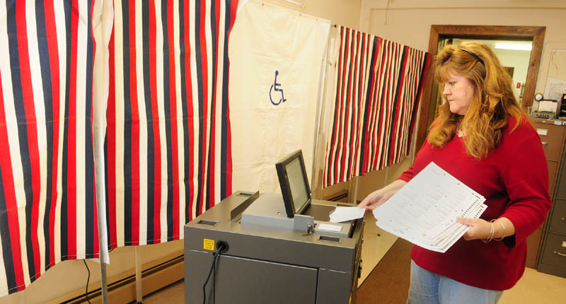 Town Clerk Lisa Gilliam runs a test on Chelsea's new IntElect DS200 electronic ballot-counting machine on Friday afternoon.