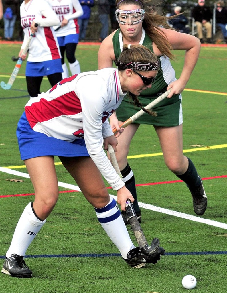 DISH IT OFF: Messalonskee’s Lynnae Luettich passes the ball as Oxford Hill’s Gabby Goodall approaches during the Eagles 11-0 win in an Eastern A quarterfinal game Tuesday in Oakland.