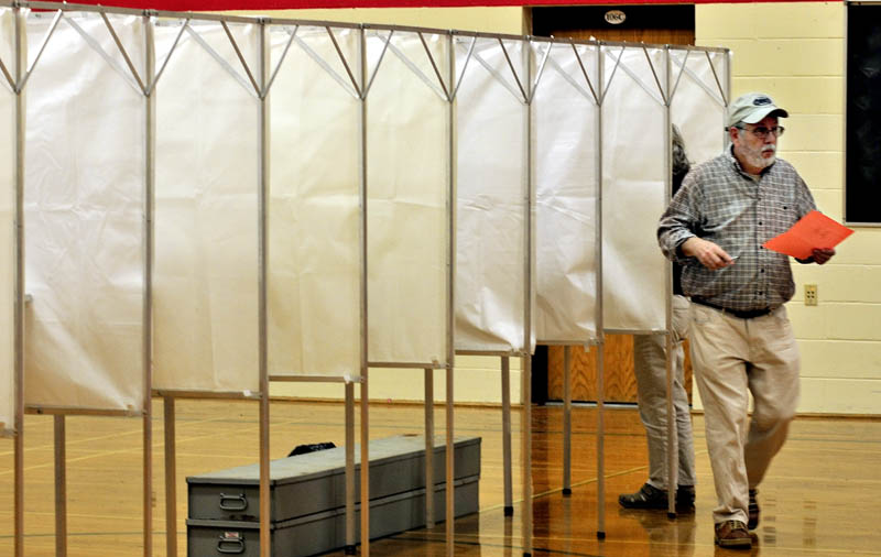 CIVIC DUTY: Frank Gifford exits an election booth after voting on the RSU 18 school budget at the Williams School in Oakland on Tuesday.