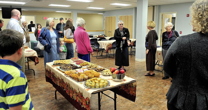 Sheila Bacon, center, leads people through the multi-use room at the new Mid-Maine Homeless Shelter in Waterville during an opening of the facility on Monday.