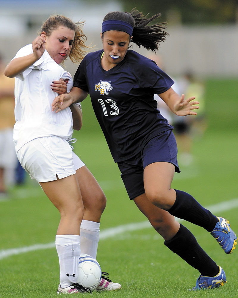 BATTLE FOR POSSESION: Mt. Blue High School’s Kiana Thompson, right, battles for the ball with Cony High School’s Lindsey Folsom during the Rams’ 2-1 win Tuesday in Augusta.